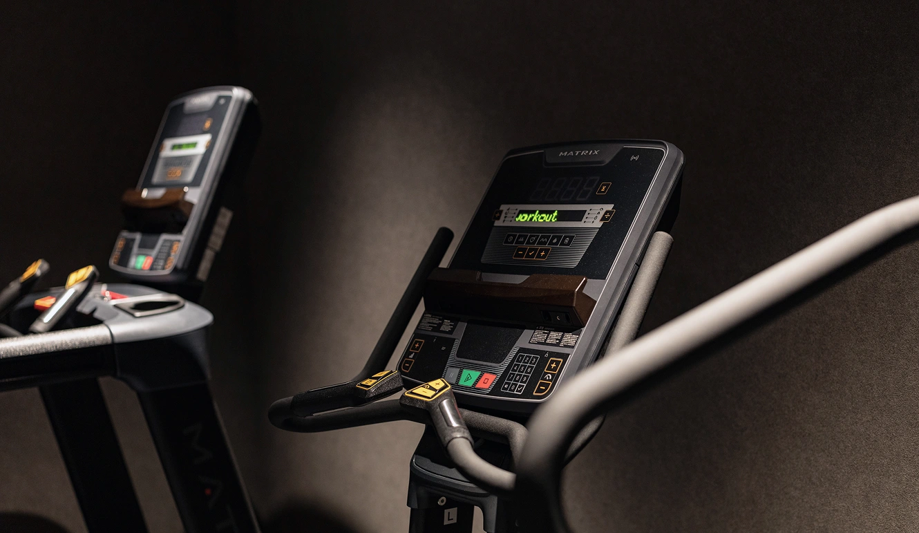 Two MATRIX training machines are lined up in a darkened room.